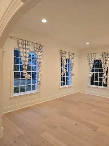 Freshly painted Pflugerville interior with crisp white trim, soft neutral walls, and natural light
